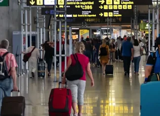 Turistas extranjeros pagarán 36% más por entrar a México: a dónde va el dinero del DNR Turistas con maletas en la terminal de un aeropuerto